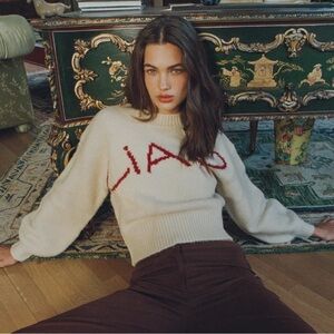 With Jean Cream and Red Sweater